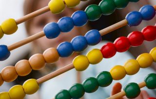 Image of an abacus. Learn how life insurance premiums are calculated.