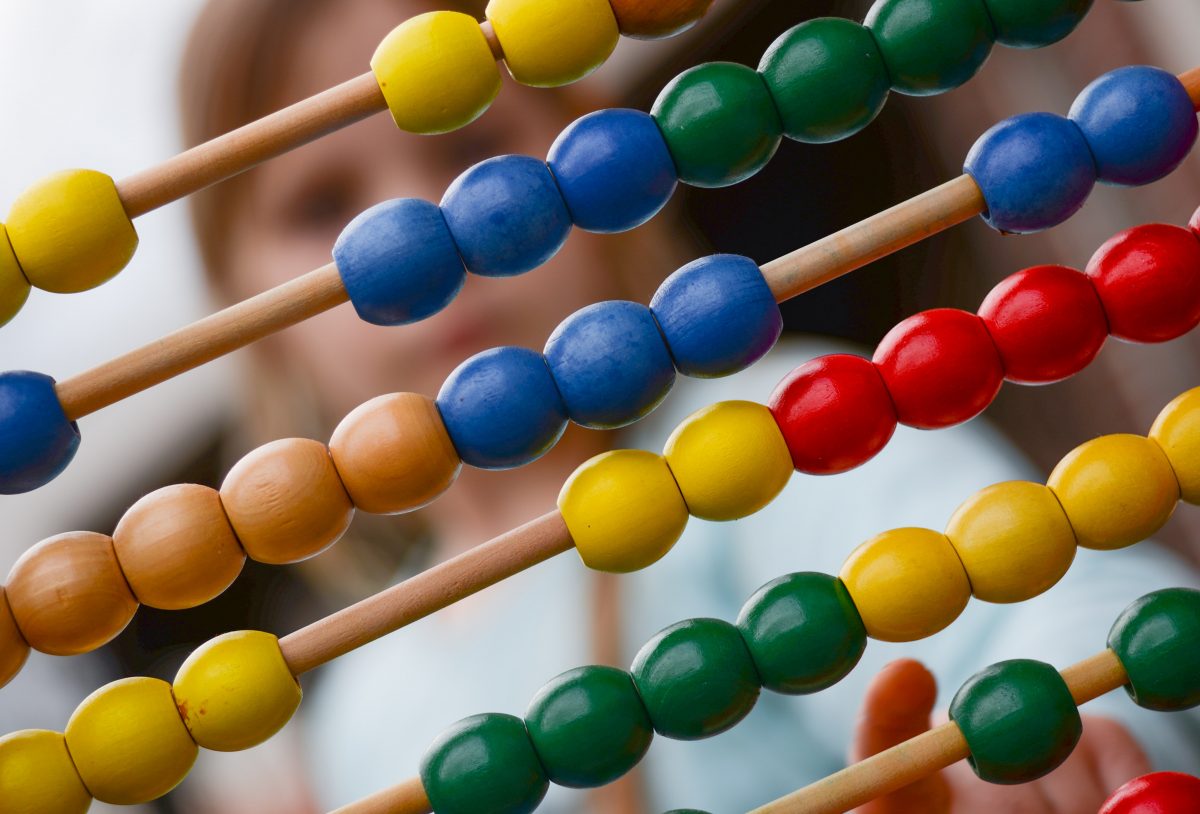 Image of an abacus. Learn how life insurance premiums are calculated.